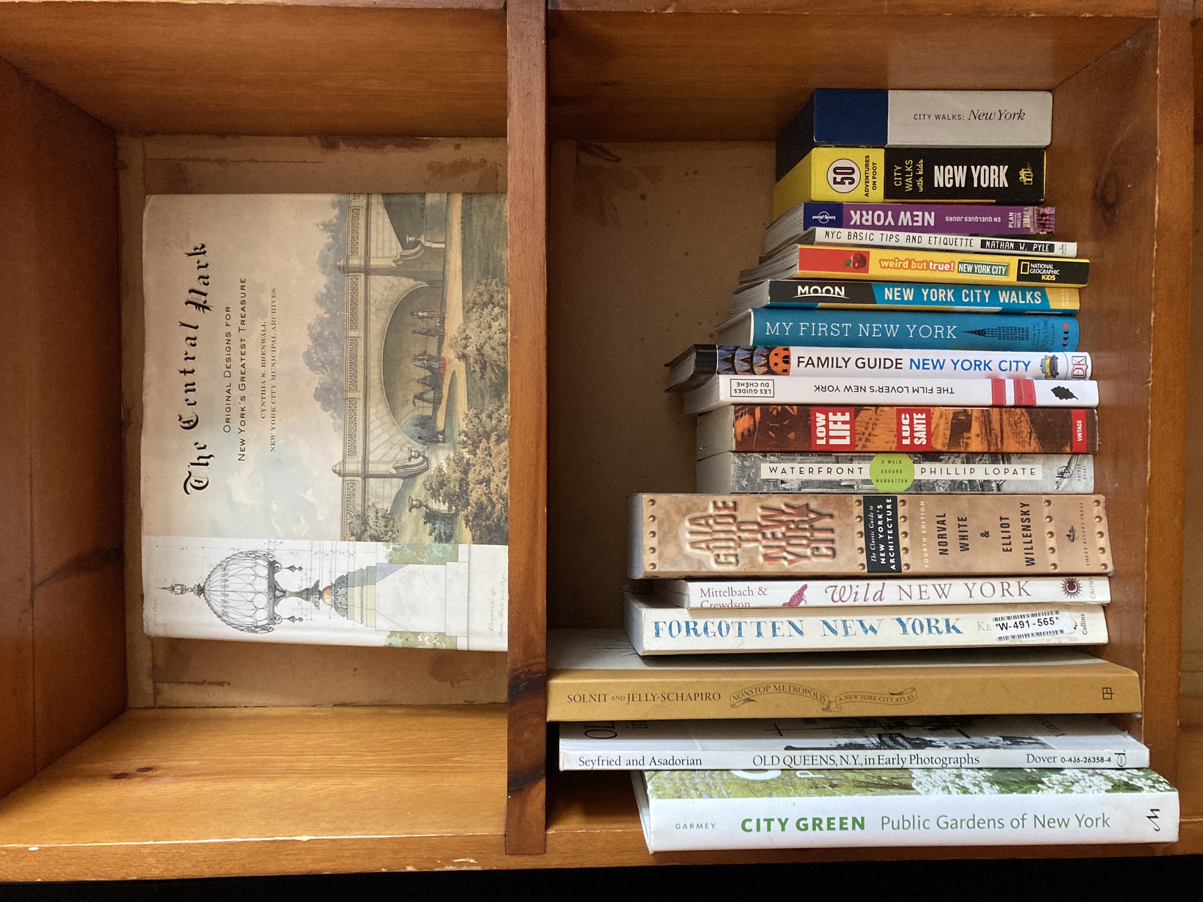 Shelf of New York City books provided for guests
